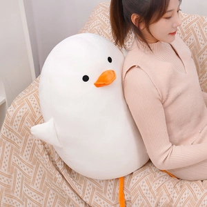 Detailed macro view of a cute white duck plush toy shell used as a soft back cushion on a sofa