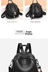 Close-up of black PU leather backpack with multiple zippers and a cute cow plush pendant
