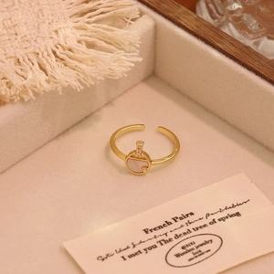Detail shot of vintage 18K gold plated ring with white shell inlay in a velvet jewelry box