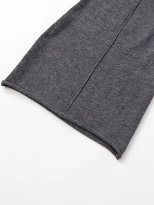 Detail shot of dark gray ribbed knit fabric with rolled cuff and precise seam stitching