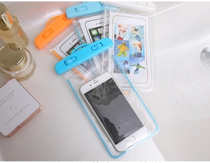 Luminous PVC waterproof phone cases in blue, orange, and white stacked on a vanity counter