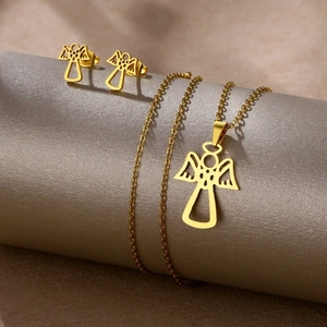 Golden stainless steel angel heart jewelry set with necklace and earrings on a pedestal