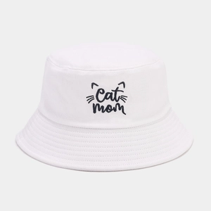 Close-up of Cat Mom embroidery on a white cotton bucket hat with fine stitching