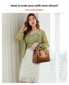 Elegant large brown leather handbag with sturdy handles styled with a stylish knitted top
