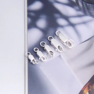 Macro detail of five sizes of s925 sterling silver lobster clasps for jewelry making