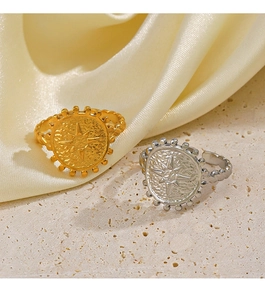 Macro detail of 18K gold starburst signet ring on elegant silk and stone textures