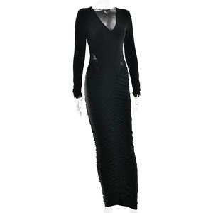 Détail de la robe noire à manches longues avec découpes à la taille et détails froncés