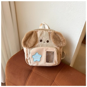 Detail of cute puppy backpack featuring plush ears and blue star patch for children