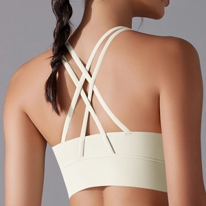 Detail showing the stylish criss-cross back straps of the cream yoga sports bra