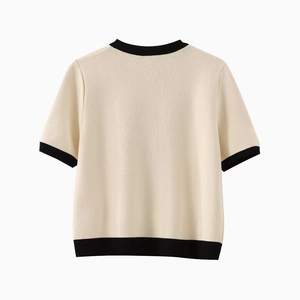 Elegant ivory knit short-sleeve top with black contrast trim, minimalist back view design