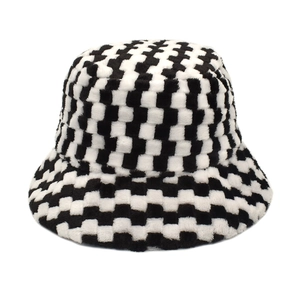 Detail of plush checkerboard bucket hat showing black and white faux fur texture
