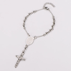 Detailed macro view of silver rosary bracelet with Virgin Mary medal and crucifix charm