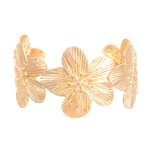 Detailed macro view of gold-finished flower bracelet with textured radial patterns