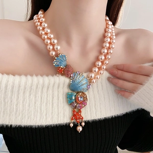 Close-up of pink double-layered pearl necklace with seashell and starfish pendant
