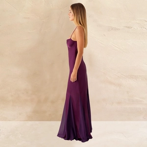 Detail of slim-fit dark purple satin evening dress featuring a patchwork flared hem