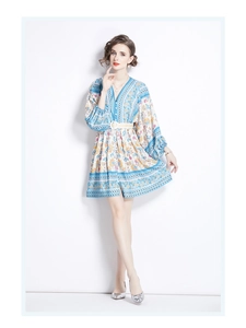 Detail of bohemian floral mini dress featuring V-neck, lantern sleeves, and matching belt