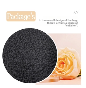 Detailed close-up showing the premium pebble grain texture of black leather tote bag