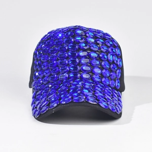 Dettaglio degli strass blu ovali incastonati su cappello da baseball nero da palcoscenico