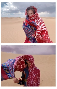 Detail of ethnic style sun protection shawl with intricate geometric patterns in desert