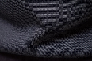 Macro shot of dark blue men hoodie fabric showing high-quality dense woven texture