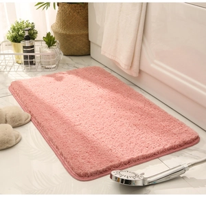 Thick pink plush bathroom rug placed near a white bathtub in a bright setting