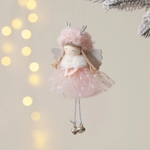 Pink plush Christmas angel ornament with silver antlers and bells on a snowy tree branch