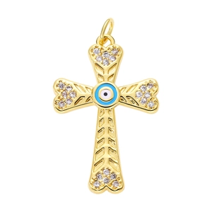 Detail of a gold-plated cross pendant featuring a blue evil eye and sparkling crystals