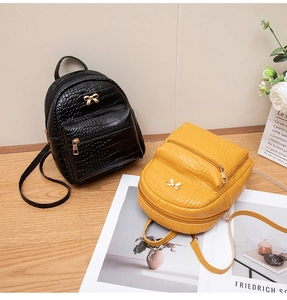 Chic mini crocodile pattern backpacks in black and yellow with gold bow accents