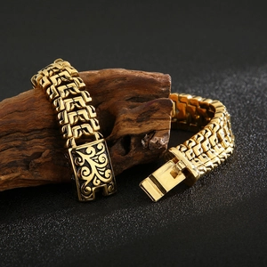 Detail of gold tree of life bracelet with intricate weave on dark textured wood background