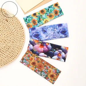 Flat lay of four floral print headbands featuring sunflower and botanical patterns