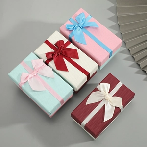 Elegant rectangular lipstick gift boxes with ribbon bows in four assorted pastel colors