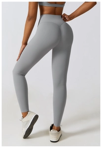 Detail showing high-waisted seamless light grey yoga leggings with booty lifting effect