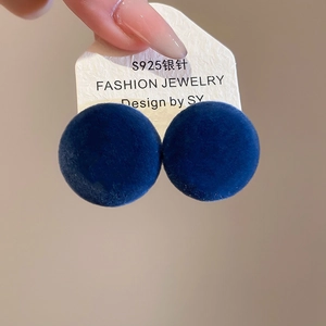 Close-up of deep blue velvet round stud earrings with S925 silver needle on card