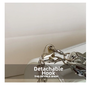 Detail of a bright chrome silver removable hook and thick metal chain for dinner bags