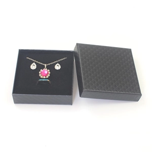 Close-up of pink gemstone jewelry set in a premium black textured gift box