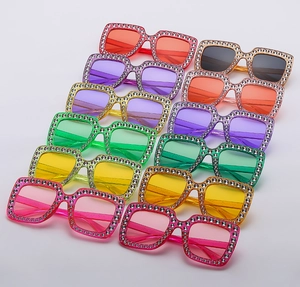 Symmetric grid of oversized square rhinestone sunglasses in various vibrant colors