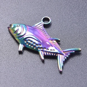 Macro view of a rainbow iridescent fish pendant with 18k plating for DIY jewelry making