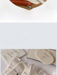 Close-up of cream ribbed knit socks showing detailed vertical stripe texture and soft fabric