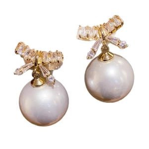 Elegant gold-plated bow earrings with pearls and crystals on a clean white background