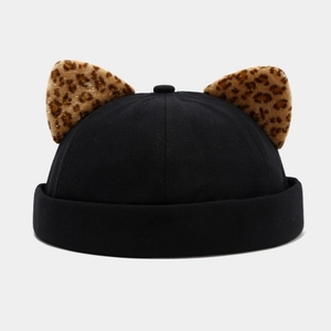 Detail of black docker hat featuring leopard print plush animal ears and canvas texture
