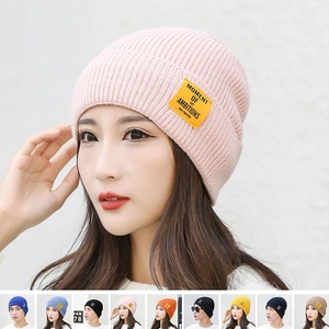 Pink sequin knit beanie with MOMENT OF AMBITIONS label for winter warmth and style