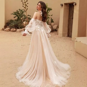 Retro off-shoulder lace wedding dress with tulle sleeves in a romantic desert setting