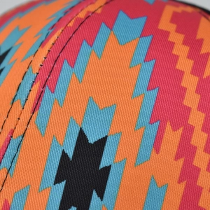 Detailed close-up of colorful geometric diamond pattern on a fabric ponytail baseball cap