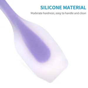 Purple translucent silicone spatula for cake baking and cream mixing on white background