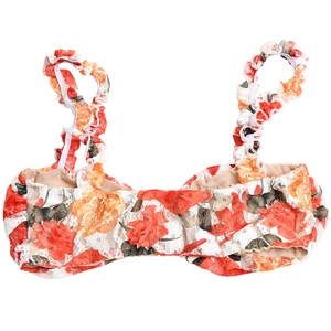 Close-up of red and orange floral lace bikini top with ruffled straps and romantic detail