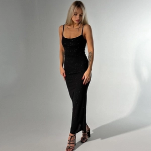 Detail of slim-fit black evening dress with sparkling sequin fabric and thin straps