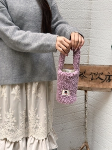 Detail of soft purple fuzzy lamb wool cup carrier bag with cute cartoon embroidery