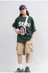 Front view of model wearing a pink transparent PVC crossbody bag with adjustable strap