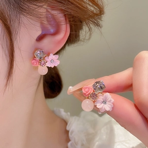 Elegant pink flower stud earrings with crystals and cat eye stone in gold-tone setting