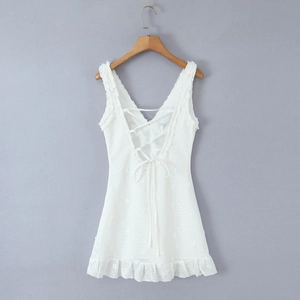 White sleeveless lace dress featuring a V-shaped open back and cross-strap detailing